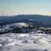 Na vrhu Velike planine pogled na pastirske stane v ozadju  Menina planina in Kašni vrh