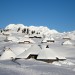 Pastirski stani na Veliki planini v ozadju Planjava in Ojstrica